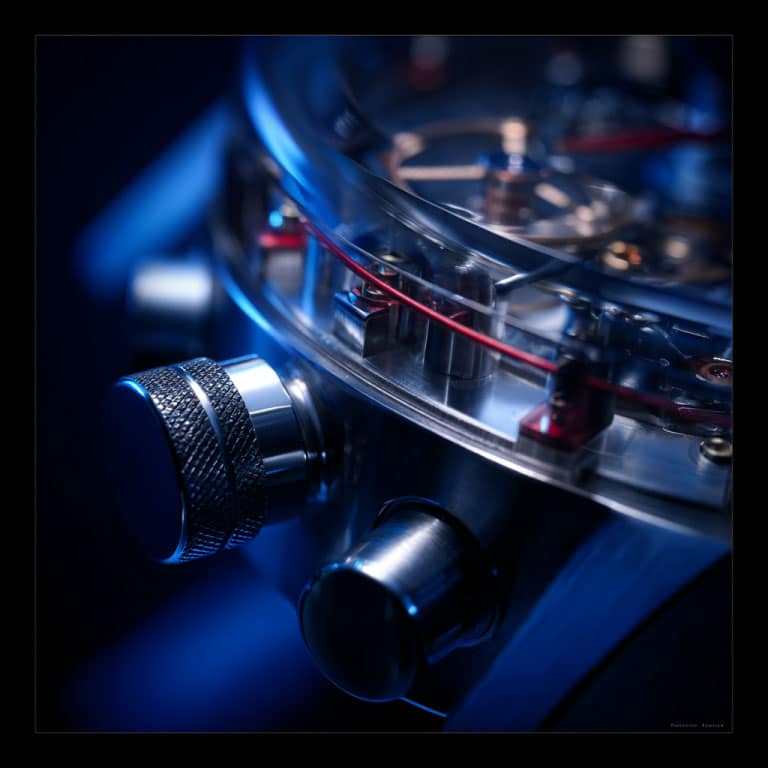 Close-up of a luxury watch mechanism with blue lighting