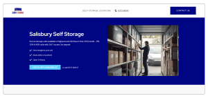 Man inside a Salisbury self-storage unit, organizing boxes. Giant Storage facility interior.